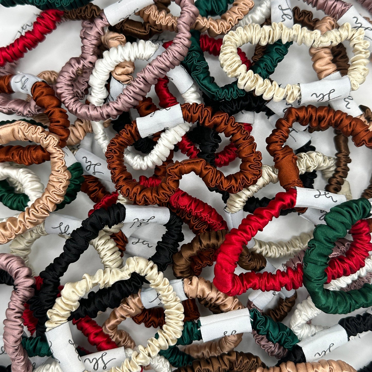 A photo showcasing all the Síoda Silky 100% Mulberry Silk scrunchies that are available in size small